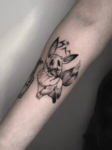 Blackwork tattoo of a dark Eevee with Japanese lettering on forearm
